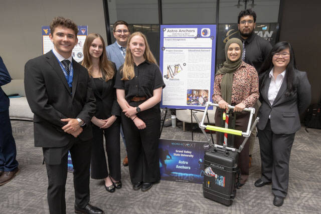 The Astro Anchors pose near their project and display